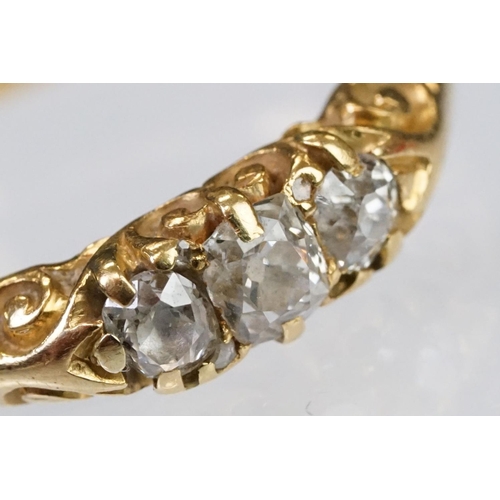 57 - Early 20th Century 18ct gold and diamond three stone ring rectangular cut diamonds set to a scrolled... 