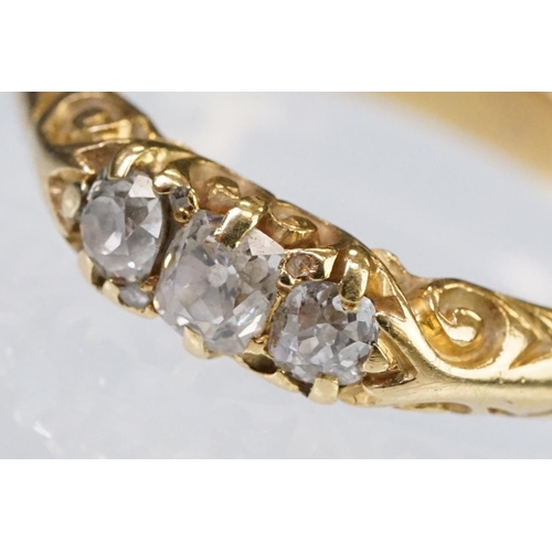 57 - Early 20th Century 18ct gold and diamond three stone ring rectangular cut diamonds set to a scrolled... 