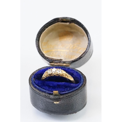 57 - Early 20th Century 18ct gold and diamond three stone ring rectangular cut diamonds set to a scrolled... 