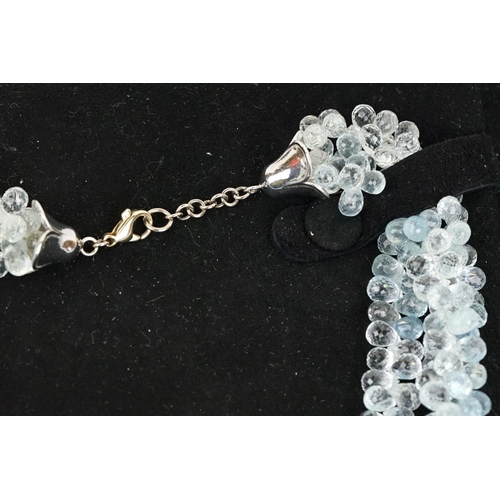 58 - Triple strand aquamarine beaded necklace, each thread with faceted aquamarine drops with forget me k... 