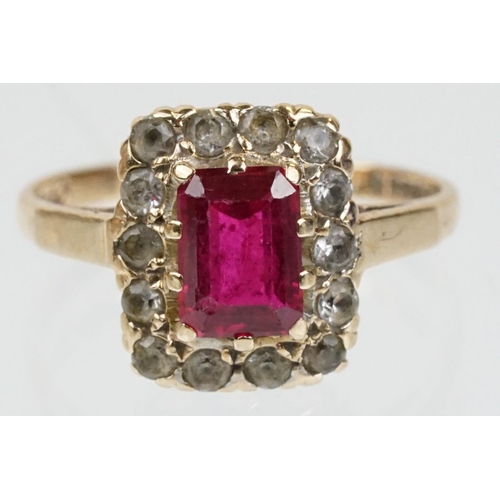 61 - 9ct gold hallmarked synthetic ruby and white stone cluster ring. The ring being set with a rectangul... 