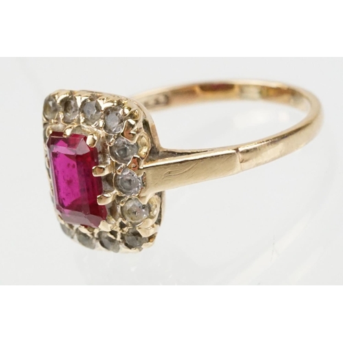 61 - 9ct gold hallmarked synthetic ruby and white stone cluster ring. The ring being set with a rectangul... 