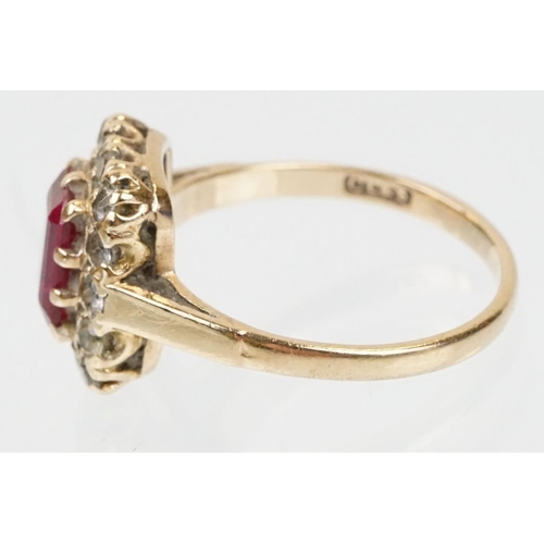 61 - 9ct gold hallmarked synthetic ruby and white stone cluster ring. The ring being set with a rectangul... 