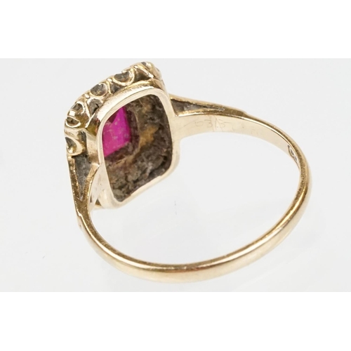 61 - 9ct gold hallmarked synthetic ruby and white stone cluster ring. The ring being set with a rectangul... 