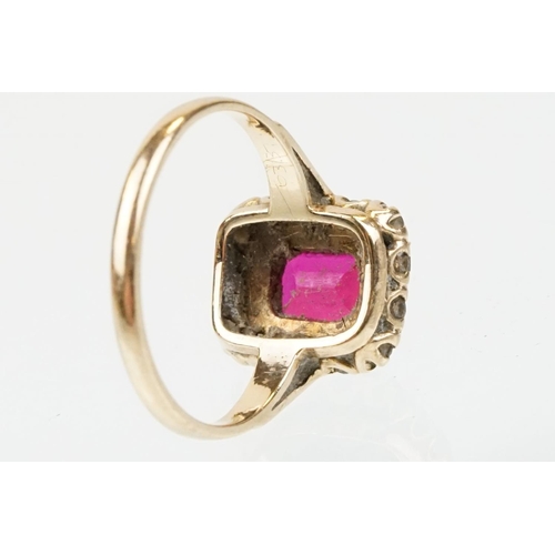 61 - 9ct gold hallmarked synthetic ruby and white stone cluster ring. The ring being set with a rectangul... 