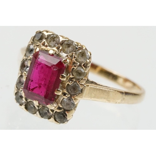 61 - 9ct gold hallmarked synthetic ruby and white stone cluster ring. The ring being set with a rectangul... 