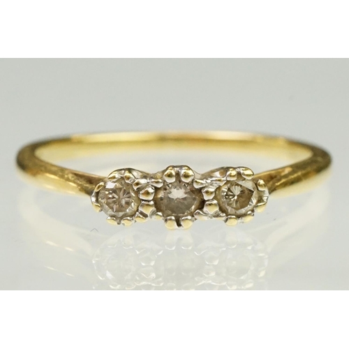 63 - 18ct yellow gold and diamond three stone ring. The ring being prong set with three round brilliant c... 