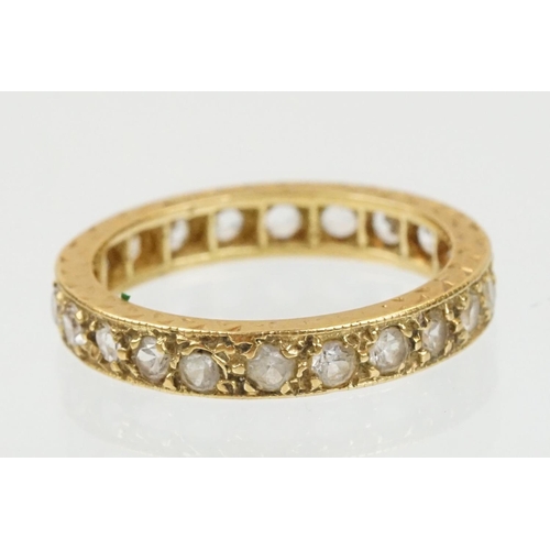 67 - 18ct and white stone eternity ring set with round cut white stones with incised detailing. Marked 18... 