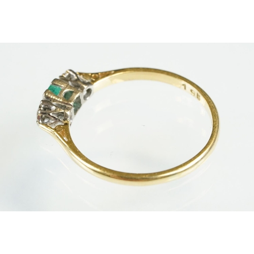 81 - 18ct gold emerald and diamond three stone ring. The ring being set with a step cut emerald flanked b... 