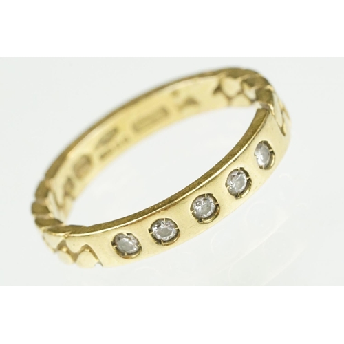 87 - 18ct gold and diamond band ring. The ring being set with five round cut diamonds with curb link deta... 