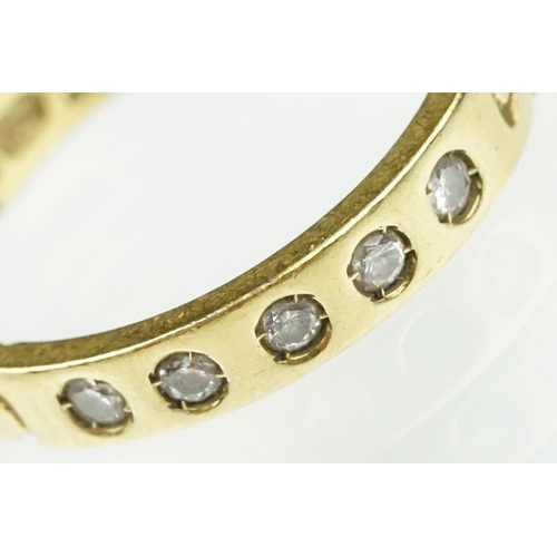 87 - 18ct gold and diamond band ring. The ring being set with five round cut diamonds with curb link deta... 