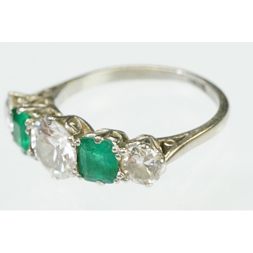 9 - Diamond and emerald five stone ring being set with a round cut diamond to the centre flanked by two ... 