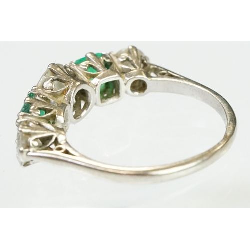 9 - Diamond and emerald five stone ring being set with a round cut diamond to the centre flanked by two ... 