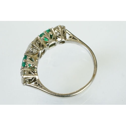 9 - Diamond and emerald five stone ring being set with a round cut diamond to the centre flanked by two ... 