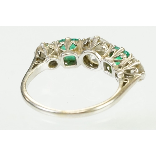 9 - Diamond and emerald five stone ring being set with a round cut diamond to the centre flanked by two ... 