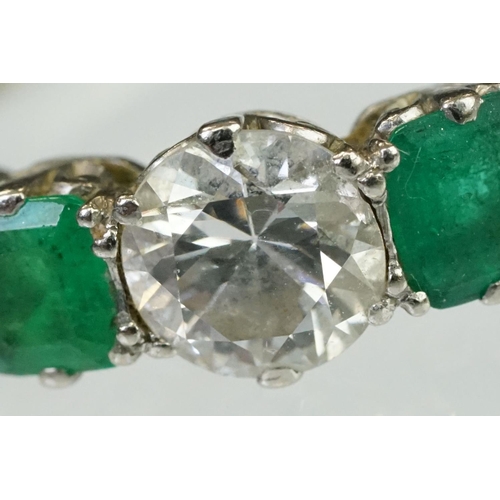 9 - Diamond and emerald five stone ring being set with a round cut diamond to the centre flanked by two ... 