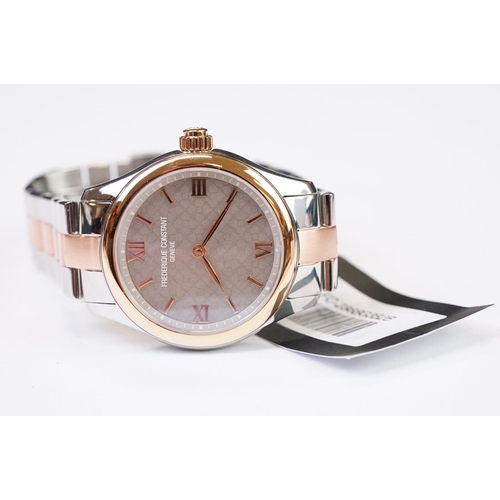 454 - A ladies Frederique Constant Geneve smart watch, bi metal case and strap with roman numeral markers,... 