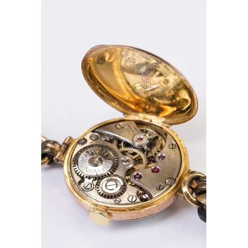 466 - A 1930's fully hallmarked ladies Marvin 9ct gold cased wristwatch with Silvered dial, mounted to bla... 