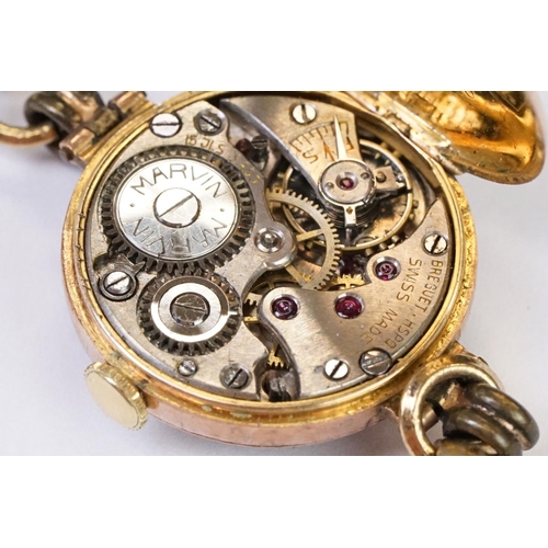 466 - A 1930's fully hallmarked ladies Marvin 9ct gold cased wristwatch with Silvered dial, mounted to bla... 