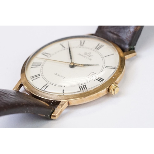 470 - A gents 9ct gold cased Marvin Quartz wristwatch, roman numeral markers with date function to 3 o'clo... 