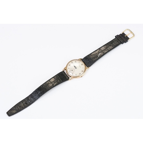 474 - A gents 9ct gold cased Garrard mechanical wristwatch, sub second dial to 6 o'clock, mounted to black... 