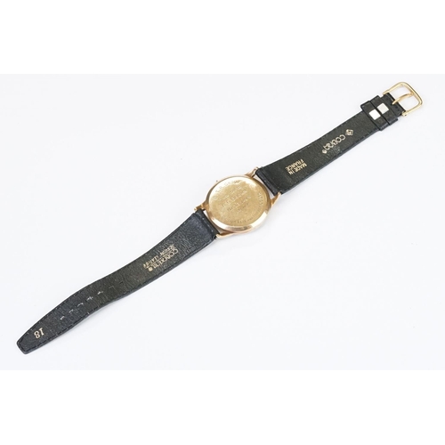 474 - A gents 9ct gold cased Garrard mechanical wristwatch, sub second dial to 6 o'clock, mounted to black... 