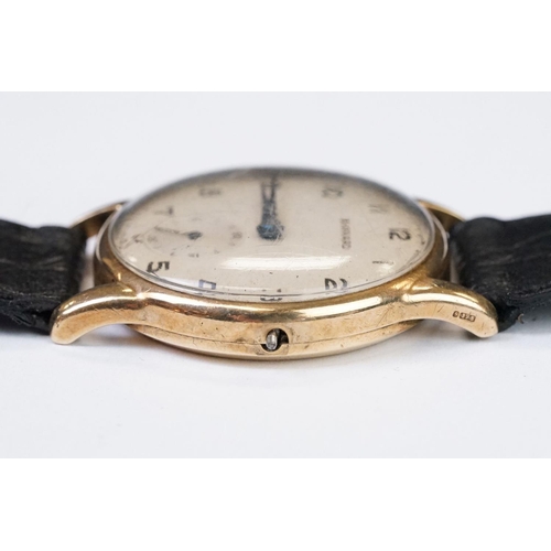 474 - A gents 9ct gold cased Garrard mechanical wristwatch, sub second dial to 6 o'clock, mounted to black... 