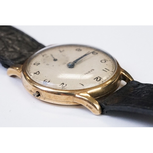 474 - A gents 9ct gold cased Garrard mechanical wristwatch, sub second dial to 6 o'clock, mounted to black... 