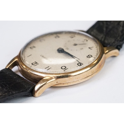 474 - A gents 9ct gold cased Garrard mechanical wristwatch, sub second dial to 6 o'clock, mounted to black... 