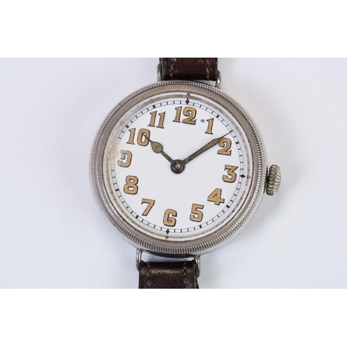 483 - An early 20th century military style trench watch, white enamel dial with numerical hour markers, mo... 