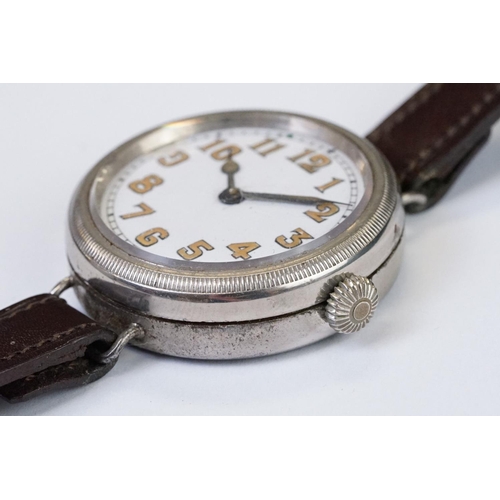 483 - An early 20th century military style trench watch, white enamel dial with numerical hour markers, mo... 