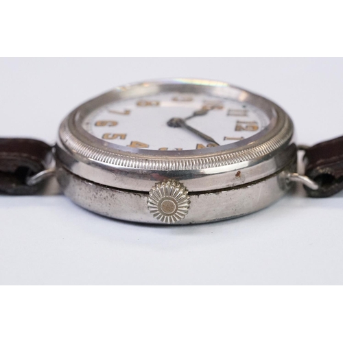 483 - An early 20th century military style trench watch, white enamel dial with numerical hour markers, mo... 