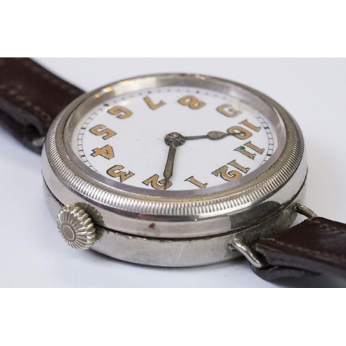 483 - An early 20th century military style trench watch, white enamel dial with numerical hour markers, mo... 