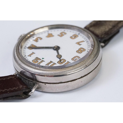 483 - An early 20th century military style trench watch, white enamel dial with numerical hour markers, mo... 