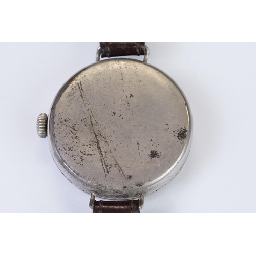 483 - An early 20th century military style trench watch, white enamel dial with numerical hour markers, mo... 