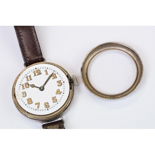 483 - An early 20th century military style trench watch, white enamel dial with numerical hour markers, mo... 