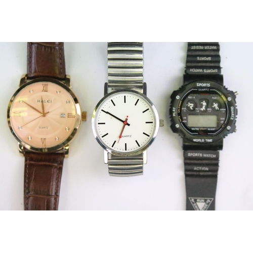 435 - A collection of twenty five mainly contemporary quartz ladies and gents wristwatches to include anal... 