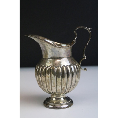 554 - Three silver hallmarked jugs to include a pair of Walker and Hall gravy jugs with moulded rims (hall... 