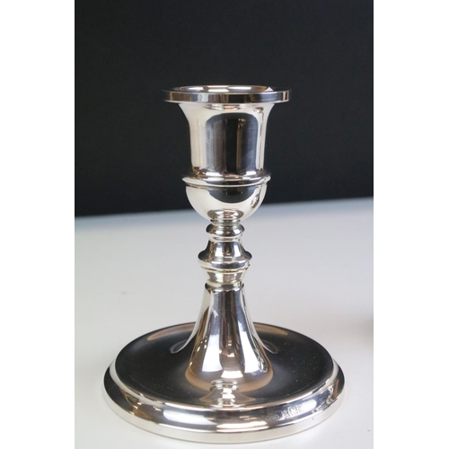 557 - Pair of silver hallmarked candlesticks having round bases, knopped columns and sconces to top. Hallm... 