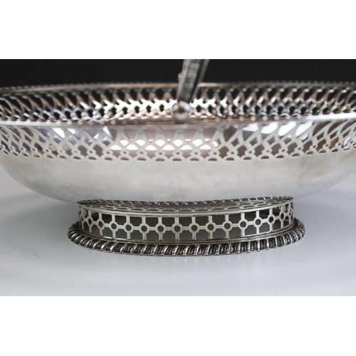 566 - Early 20th Century silver hallmarked footed basket of oval form having a pierced rim with hinged han... 