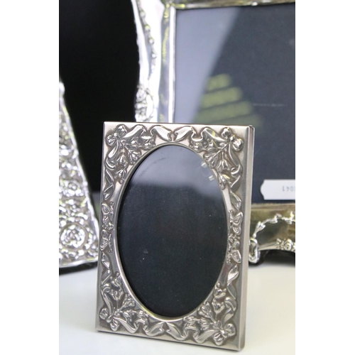 572 - Three photo frames to include a silver fronted frame with bow garland detailing (hallmarked London 1... 