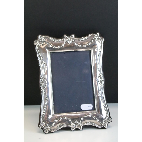 572 - Three photo frames to include a silver fronted frame with bow garland detailing (hallmarked London 1... 