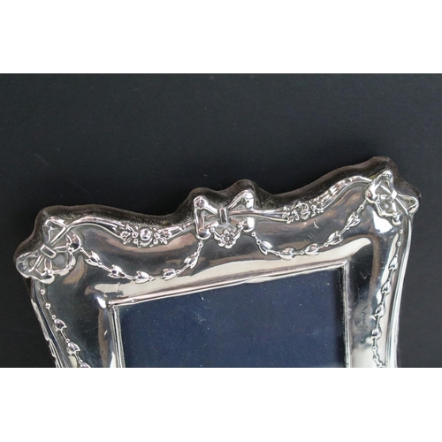 572 - Three photo frames to include a silver fronted frame with bow garland detailing (hallmarked London 1... 