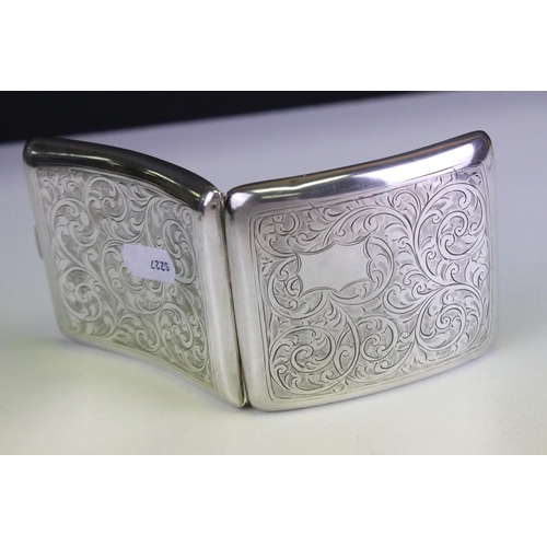 641 - George V silver cigarette case of curved rectangular form, with engraved scrolling Acanthus leaf dec... 