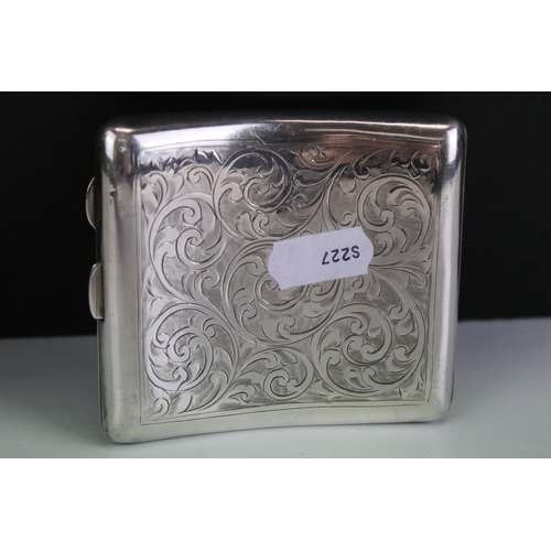 641 - George V silver cigarette case of curved rectangular form, with engraved scrolling Acanthus leaf dec... 