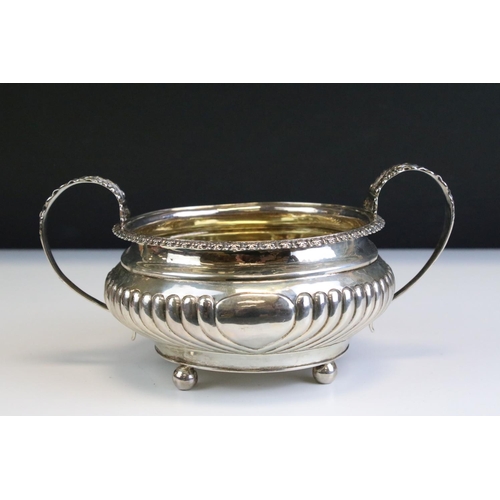 650 - George IV silver hallmarked twin handled sugar bowl having a reeded body with foliate moulded handle... 