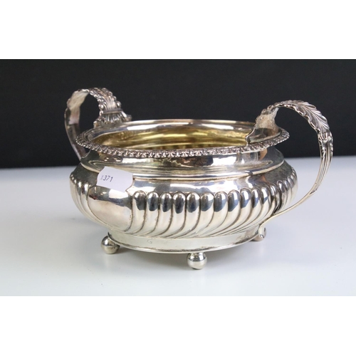 650 - George IV silver hallmarked twin handled sugar bowl having a reeded body with foliate moulded handle... 