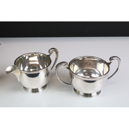 663 - Early-to-mid 20th Century four-piece silver tea set, of plain polished form with scrolled handles, c... 