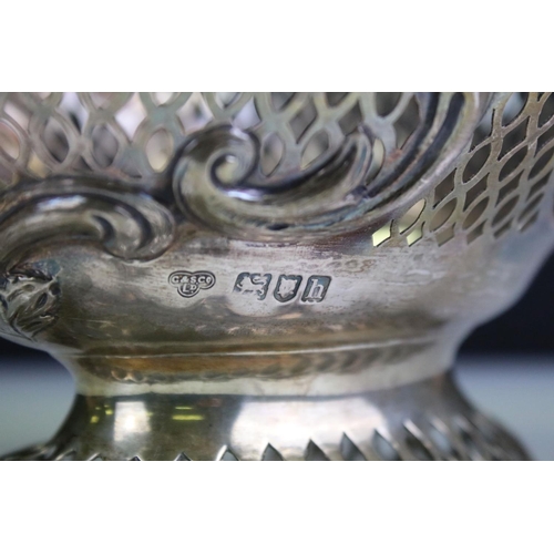 677 - Early 20th Century silver hallmarked basket of pierced form having moulded scrolled rims with floral... 