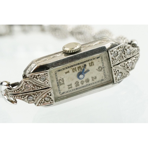 508 - Early 20th Century platinum and diamond cocktail watch having a rectangular face with arabic numeral... 